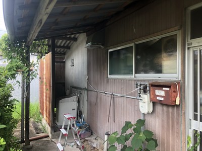 家の両端いっぱいまで波板の庇がかかっている画像